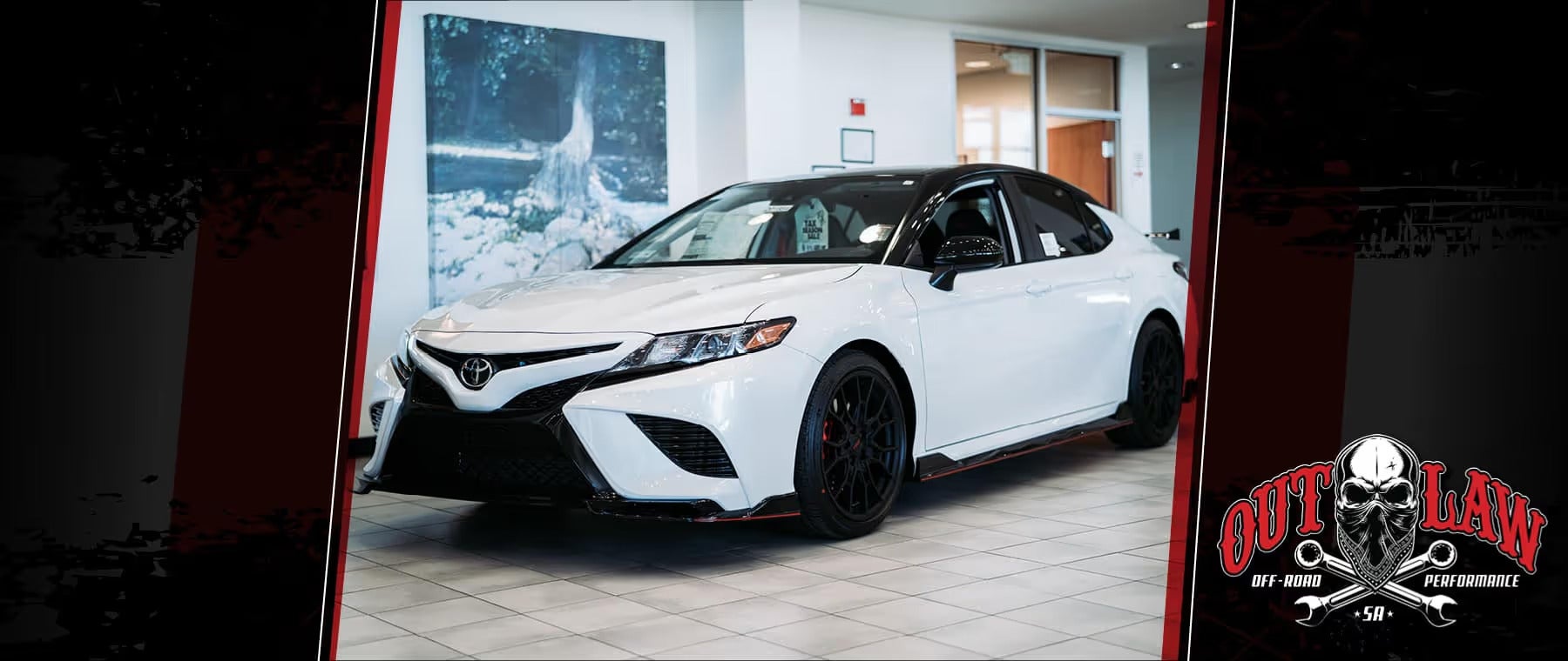 White Toyota Camry on display at Outlaw Off-Road showroom